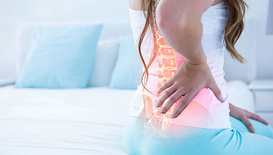 Woman suffering from subluxation in lower back before visiting Denver chiropractor