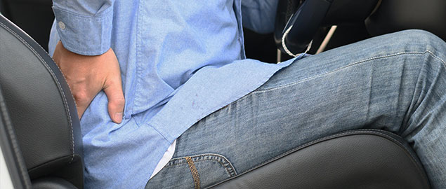 Man suffering from low back pain after car accident Denver